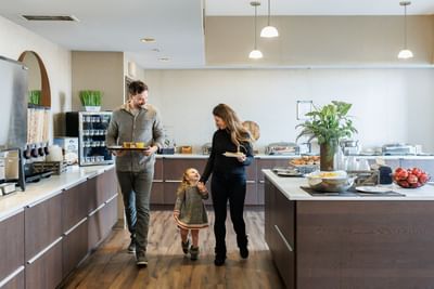 Family browses the extensive breakfast buffet selections, highlighting great Charlottetown accommodations at Rodd Royalty