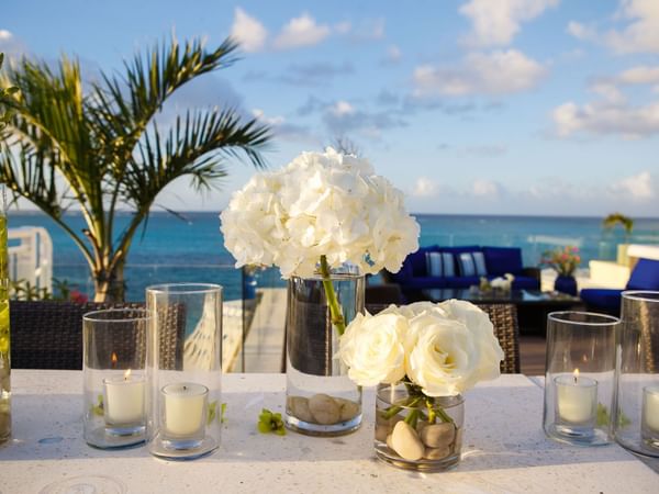White roses and candles on a table at Windsong Resort On The Reef