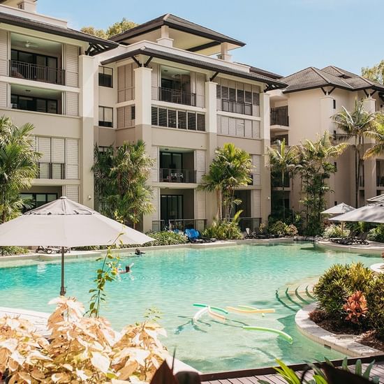 Outdoor pool with exterior of Pullman Palm Cove Sea Resort