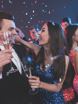 People celebrating New Year's Eve with champagne & confetti at Cove Pocono Resorts