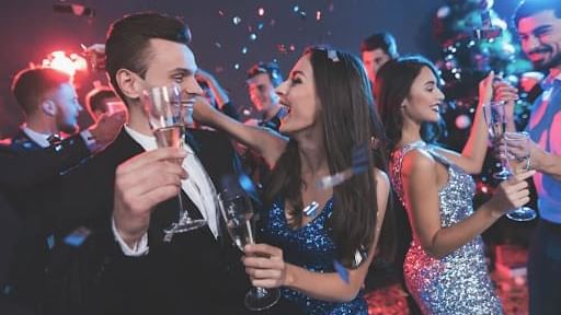 People celebrating New Year's Eve with champagne & confetti at Cove Pocono Resorts