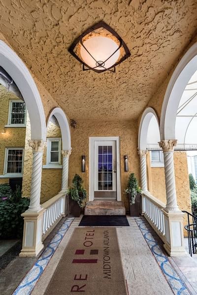 Covered hallway leading to a doorway at Artmore Hotel