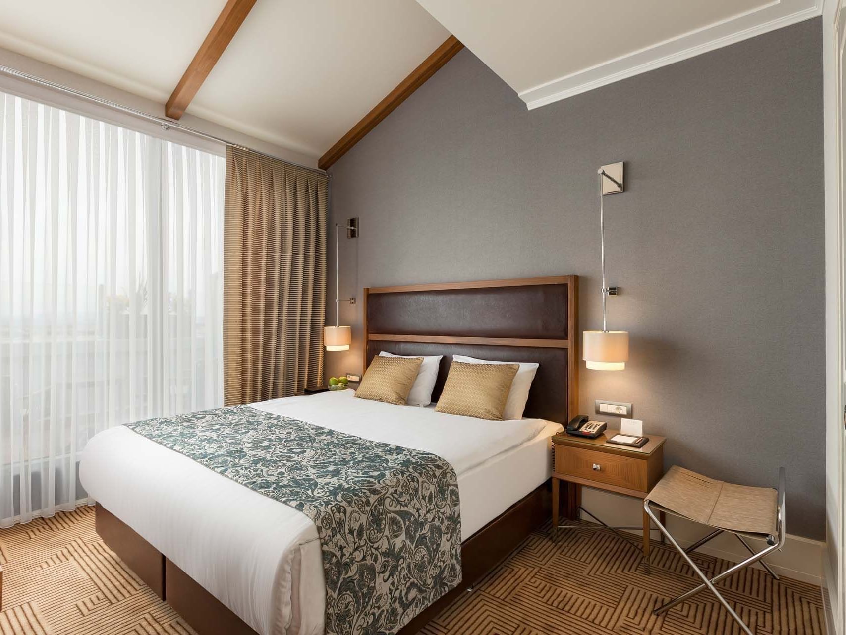 Comfy bed with side tables in Executive Room at Titanic City Taksim
