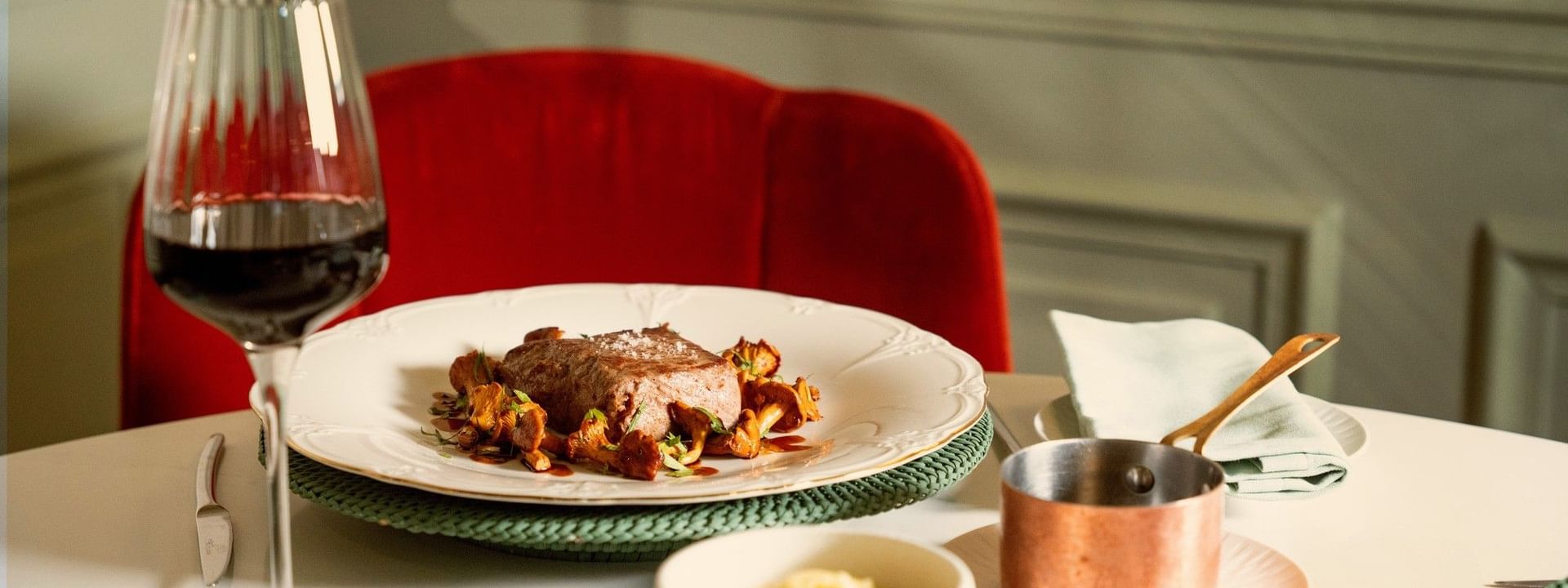 Elegant plated meat dish with red wine and copper saucepan at Le Céladon, Hôtel Westminster - Paris
