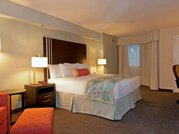 King bed in hotel room with sofa