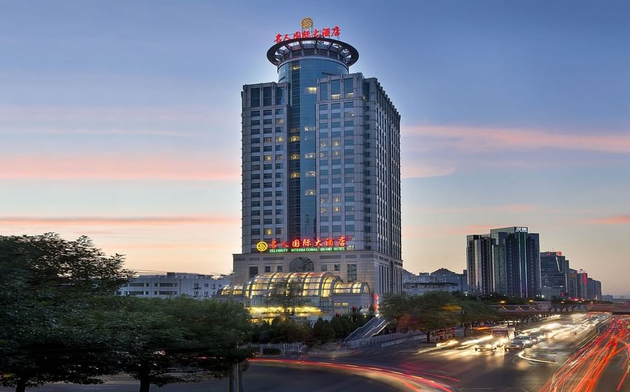 Celebrity International Grand Hotel at sunset with city traffic light trails
