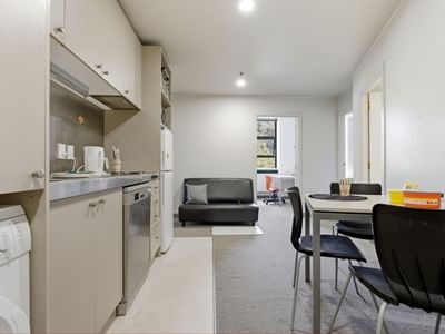 Modern kitchen and dining area with appliances, table, and seating at UniLodge Stafford House.