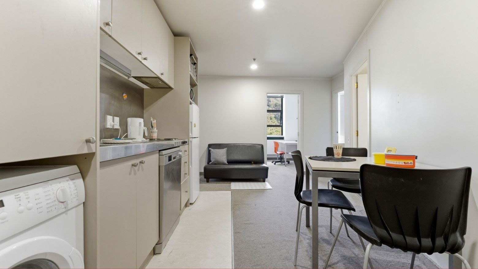 Modern kitchen and dining area with appliances and seating at UniLodge Stafford House.