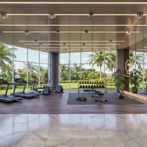 Hotel gym with treadmills by dumbbell racks and boxing bags overlooking palms at Palmeraie Golf Palace by Pickalbatros