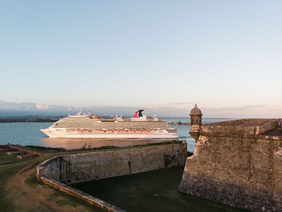 A large boat sailing in El Morro Fort and Fort San Cristobal near Las Casitas Village