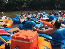 Group of people on floats at Zen Tubing near Mountain Inn & Suites