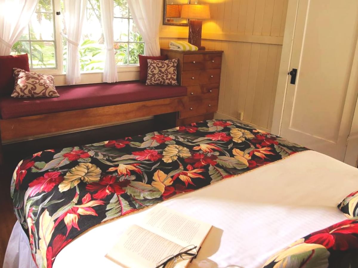 Bedroom with bed, book, couch, and lamp