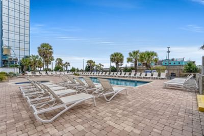 Sun beds arranged by the outdoor swimming pool at The Yachtsman Resort