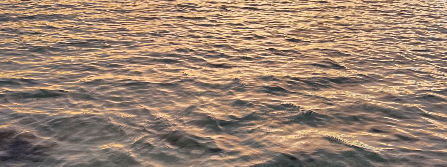 Sunset over the ocean with a tranquil water surface at Warwick Le Lagon - Vanuatu, Efate