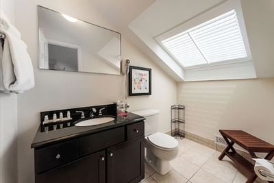 A toilet and sink in a bathroom at Artmore Hotel