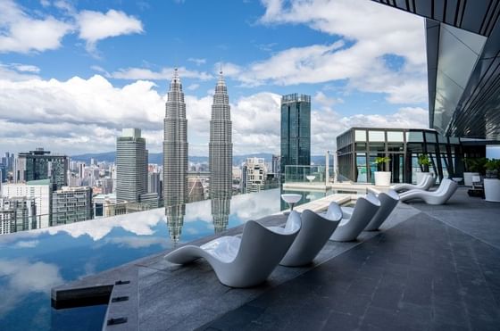 Sky Infinity Pool with sun loungers & cityscape view at Imperial Lexis Kuala Lumpur