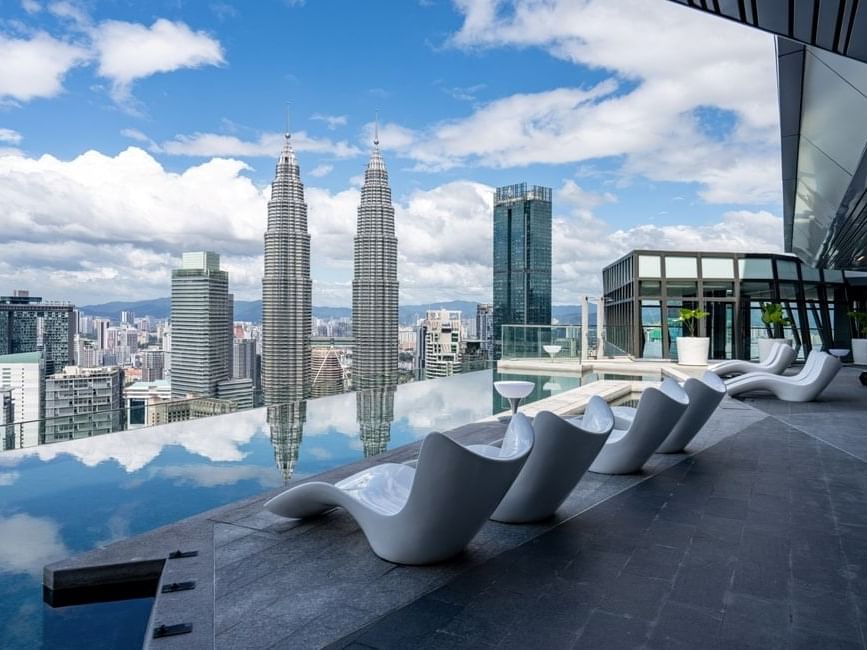 Sky Infinity Pool with sun loungers & cityscape view at Imperial Lexis Kuala Lumpur