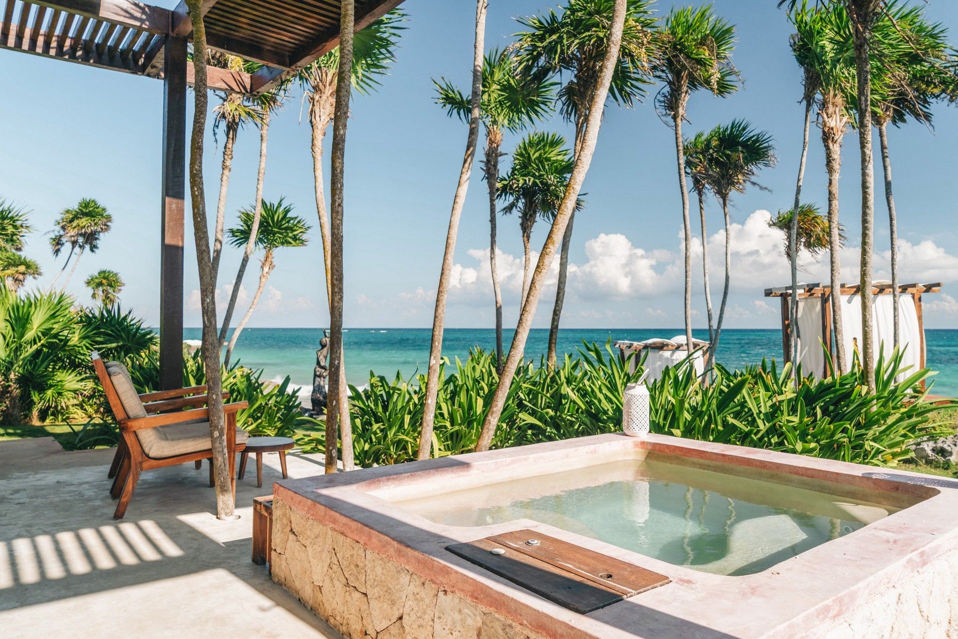 Private plunge pool and terrace framed by palms with the Caribbean Sea beyond