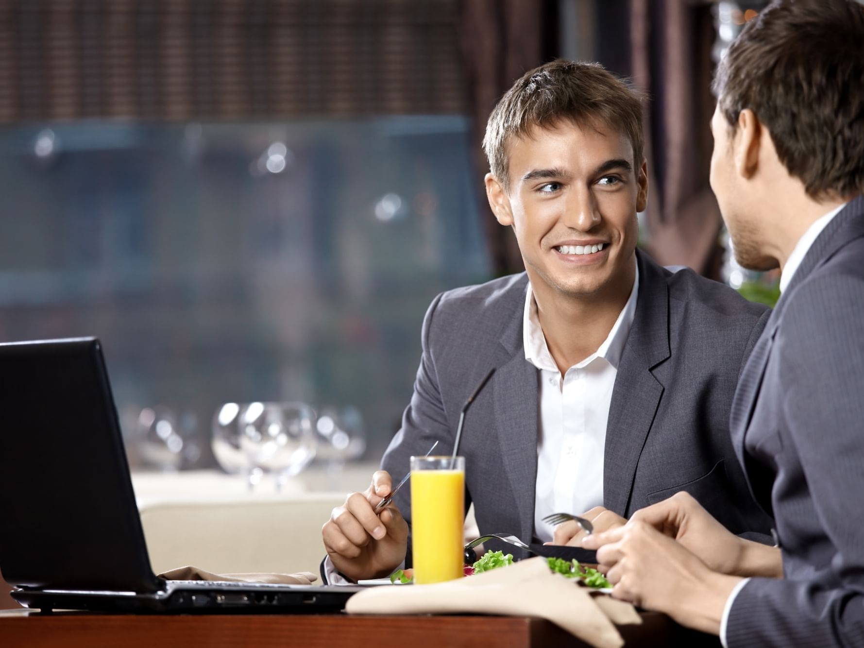 Men in suits on a meeting while dining at City Seasons Hotel