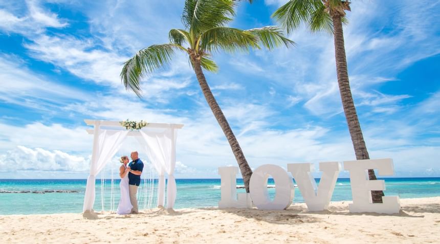 Couple holding hands in chiffon backdrop at Sugar Bay Barbados