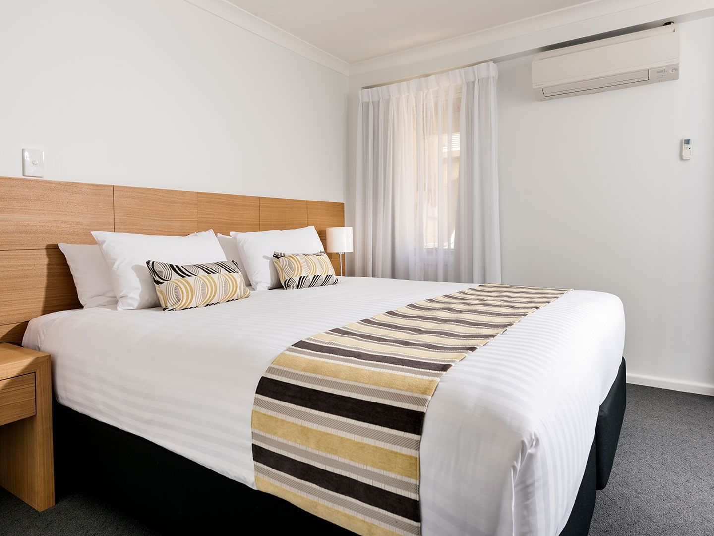 Bedroom with one bed in 2 Bedroom Ocean Sunset Spa apartment at Be Fremantle