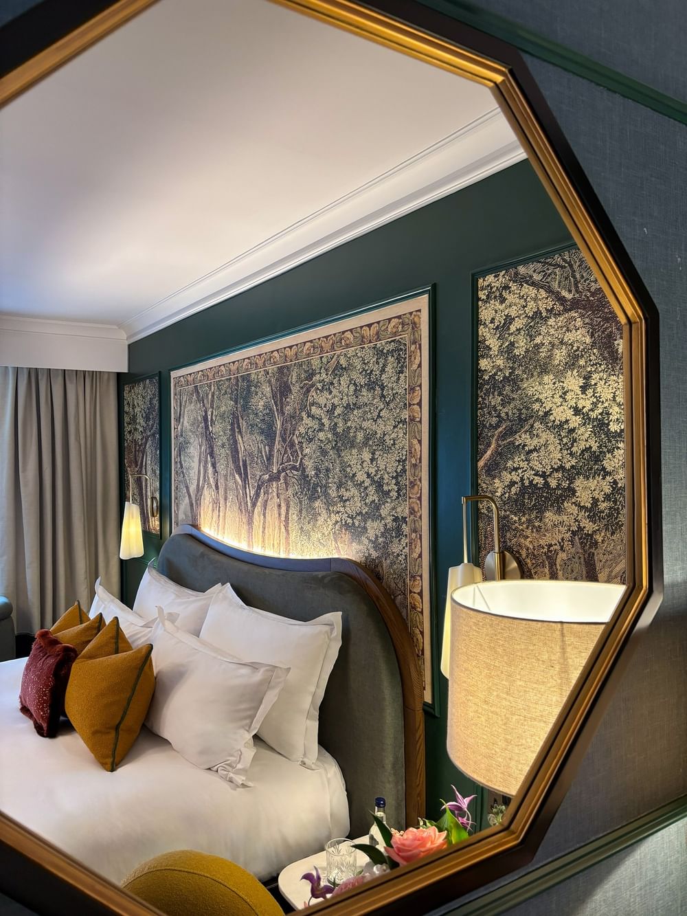 Mirror reflecting Executive Room with bed, pillows, and artwork at The Capital Hotel, Apartments & Townhouse