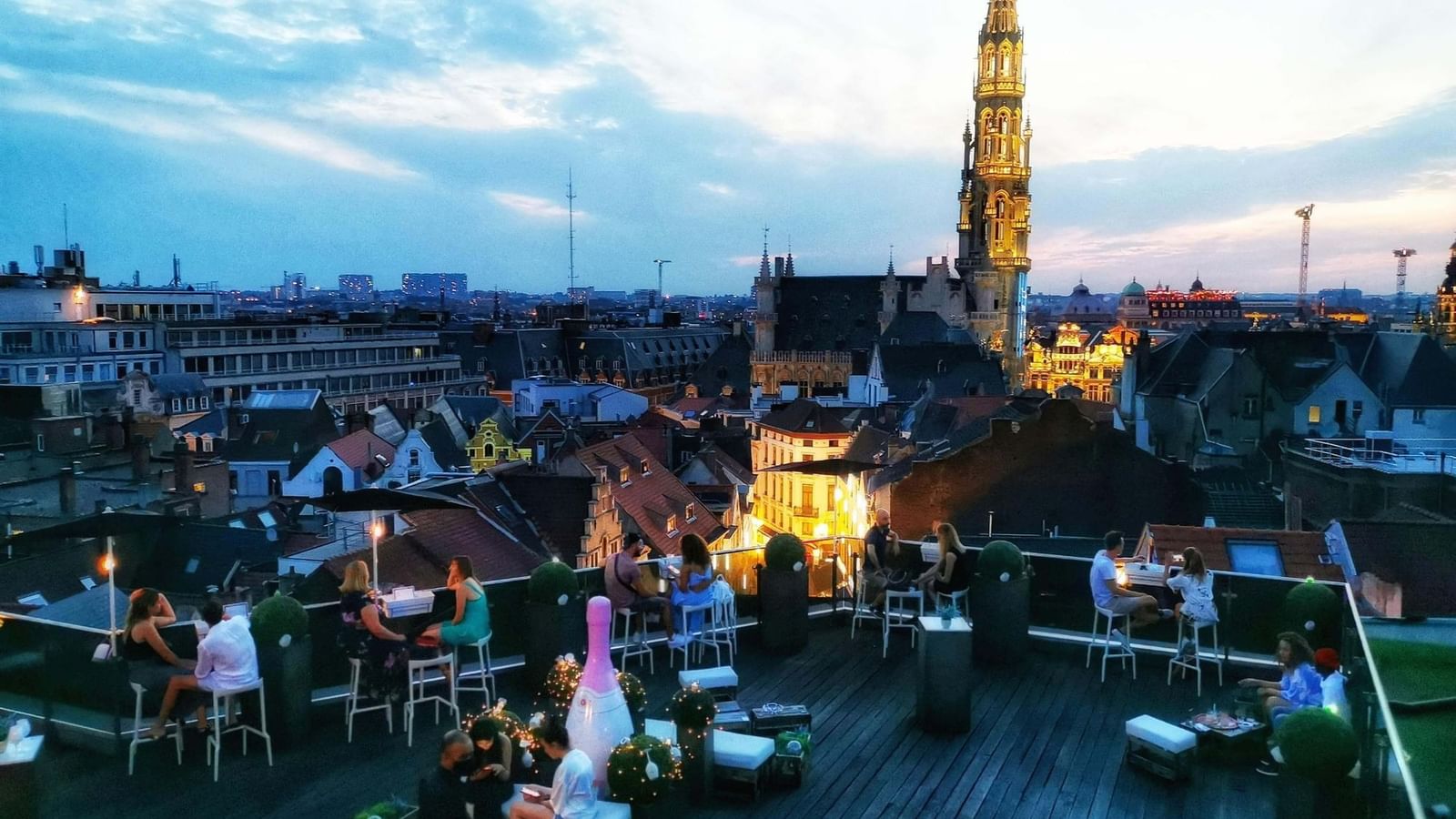 Evening rooftop terrace featuring guests enjoying drinks with city view at the Hotel Barsey by Warwick