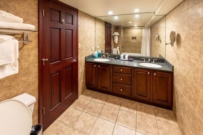 Deluxe Family Suite bathroom with double sinks and a large mirror at The Boulevard Inn & Bistro