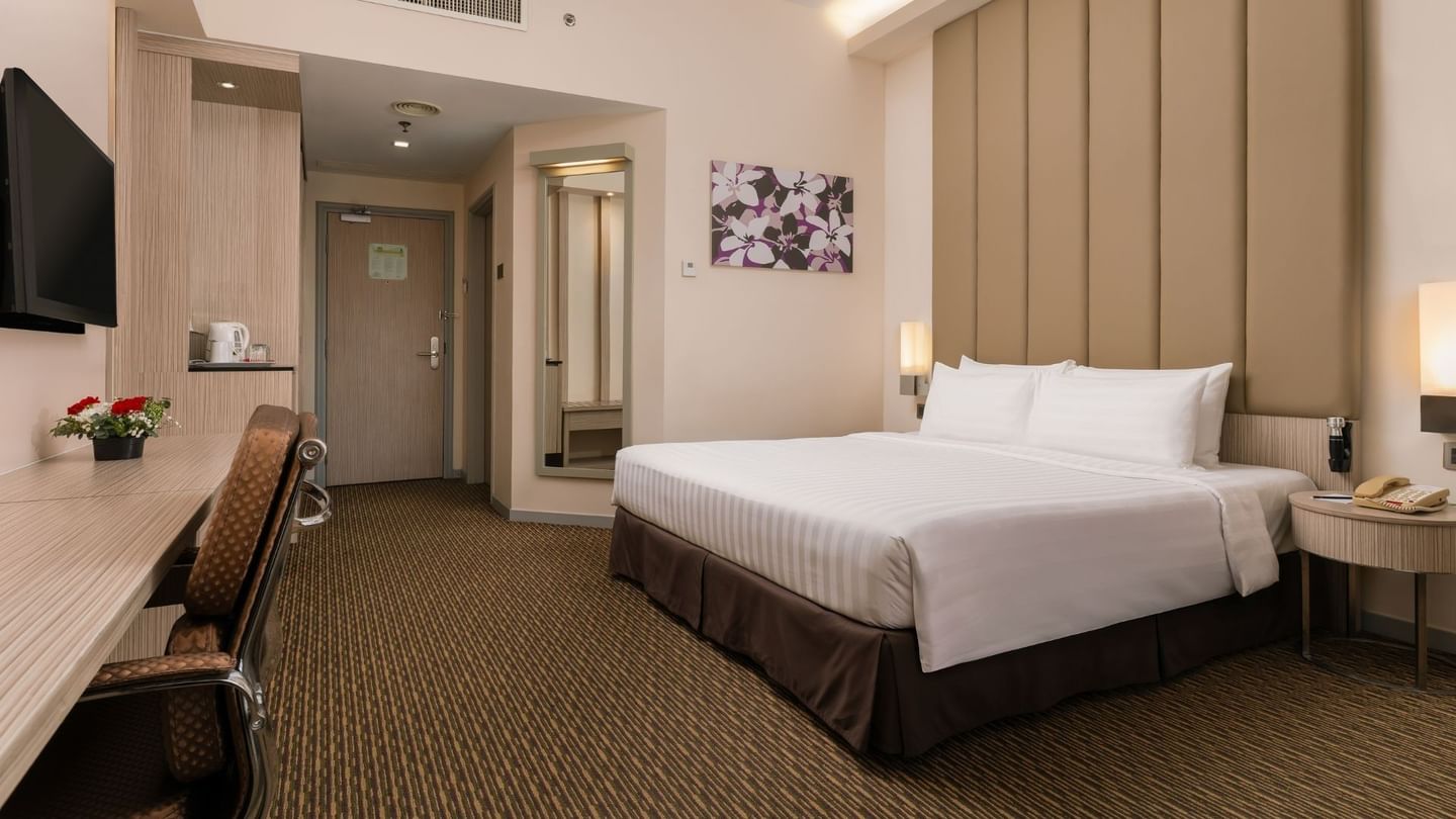 Work desk and wall mirror by the bed in Executive King Room with modern furnishings at Sunway Hotel Georgetown