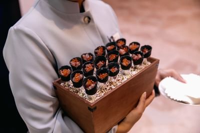 Waitress holding a dessert box at Amora Hotel Brisbane