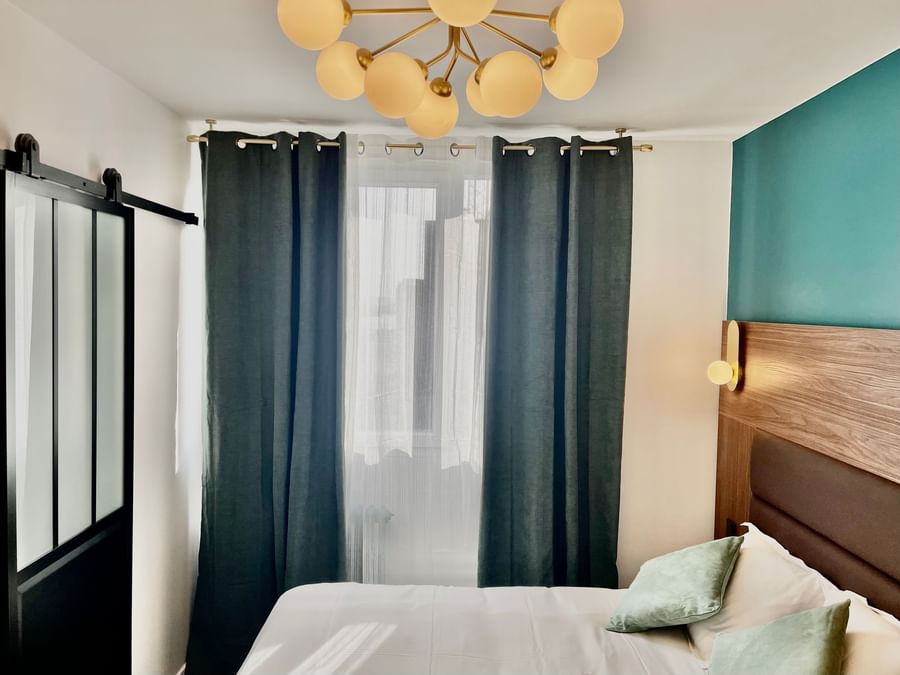 Bedroom interior in Hotel Le Marignan at The Originals Hotels