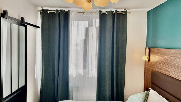 Bedroom interior in Hotel Le Marignan at The Originals Hotels