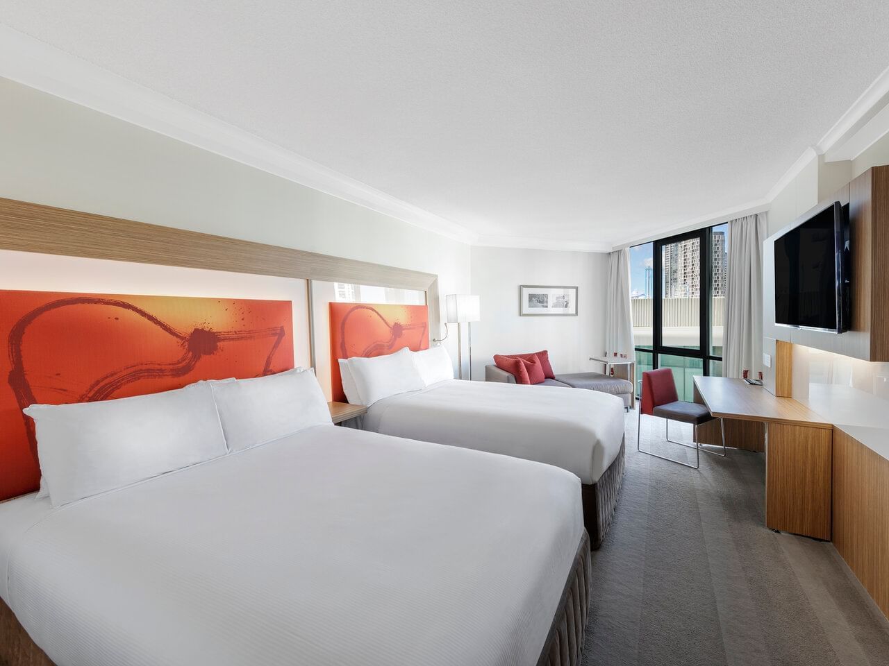 Bed with window view in Premier Double Twin Room at Amora Hotel
