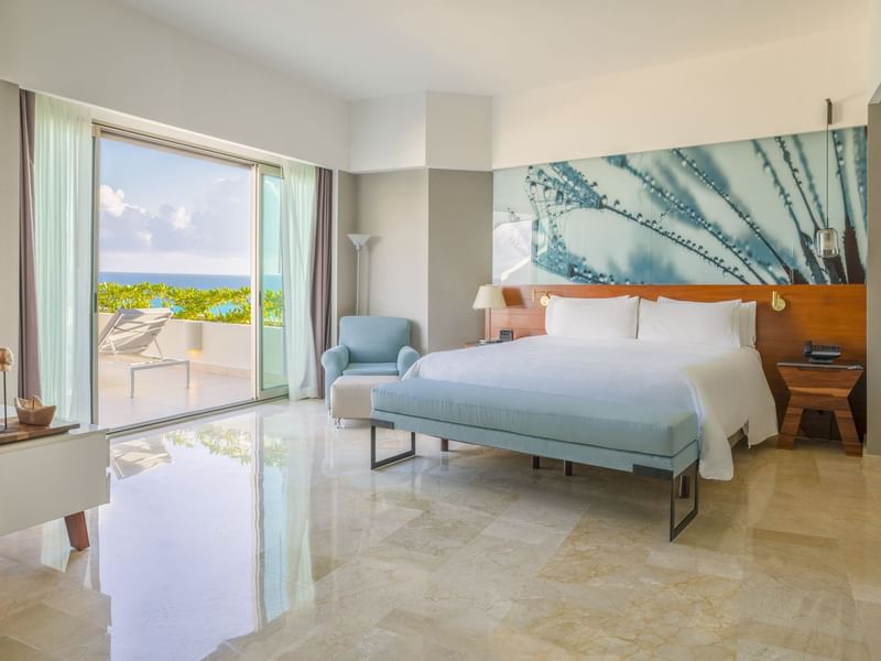 Bed and seating in a room overlooking the sea at Live Aqua Resorts and Residence Club