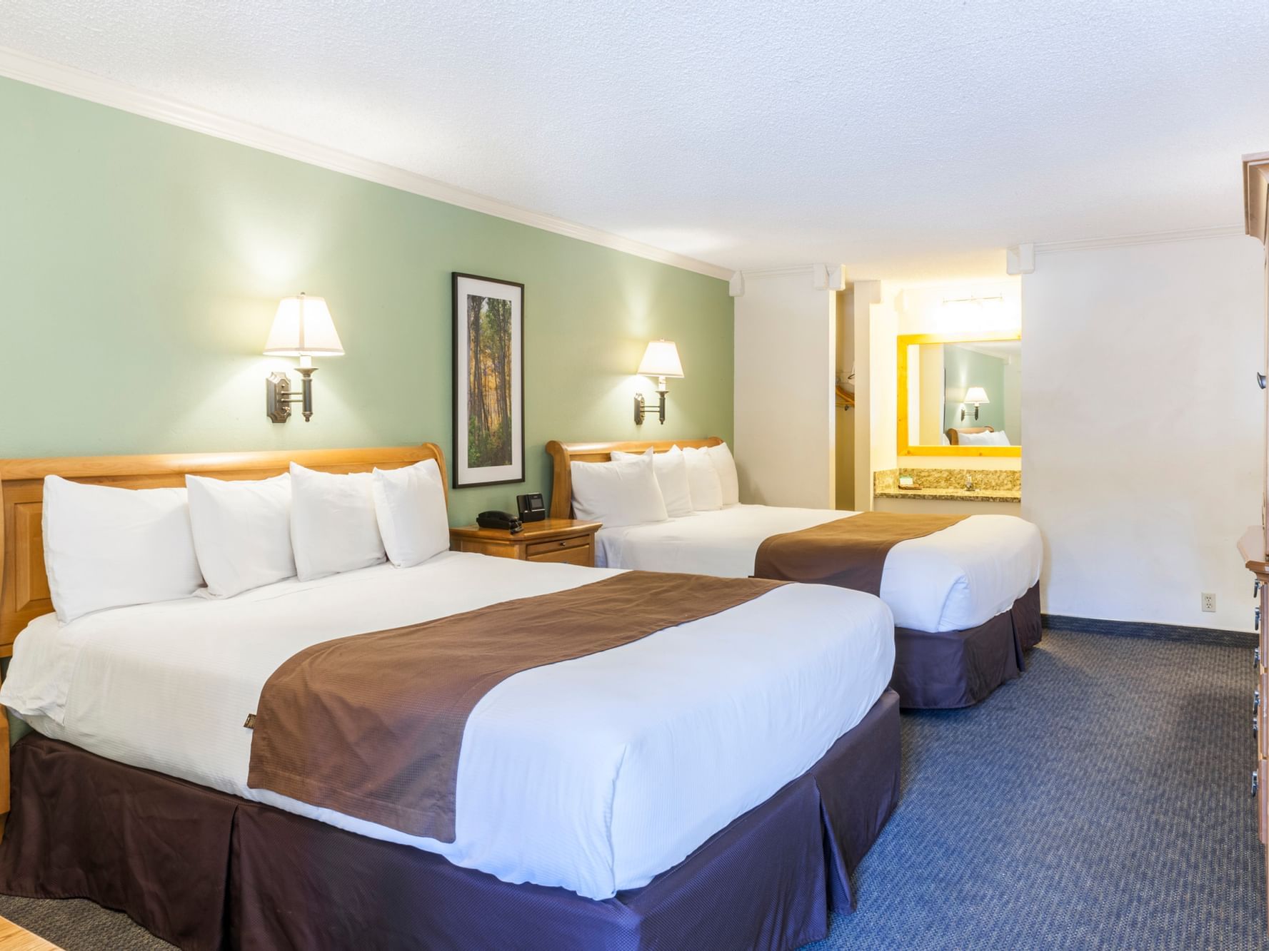 Two beds and wall sconces in King Room at Alpenhof Lodge