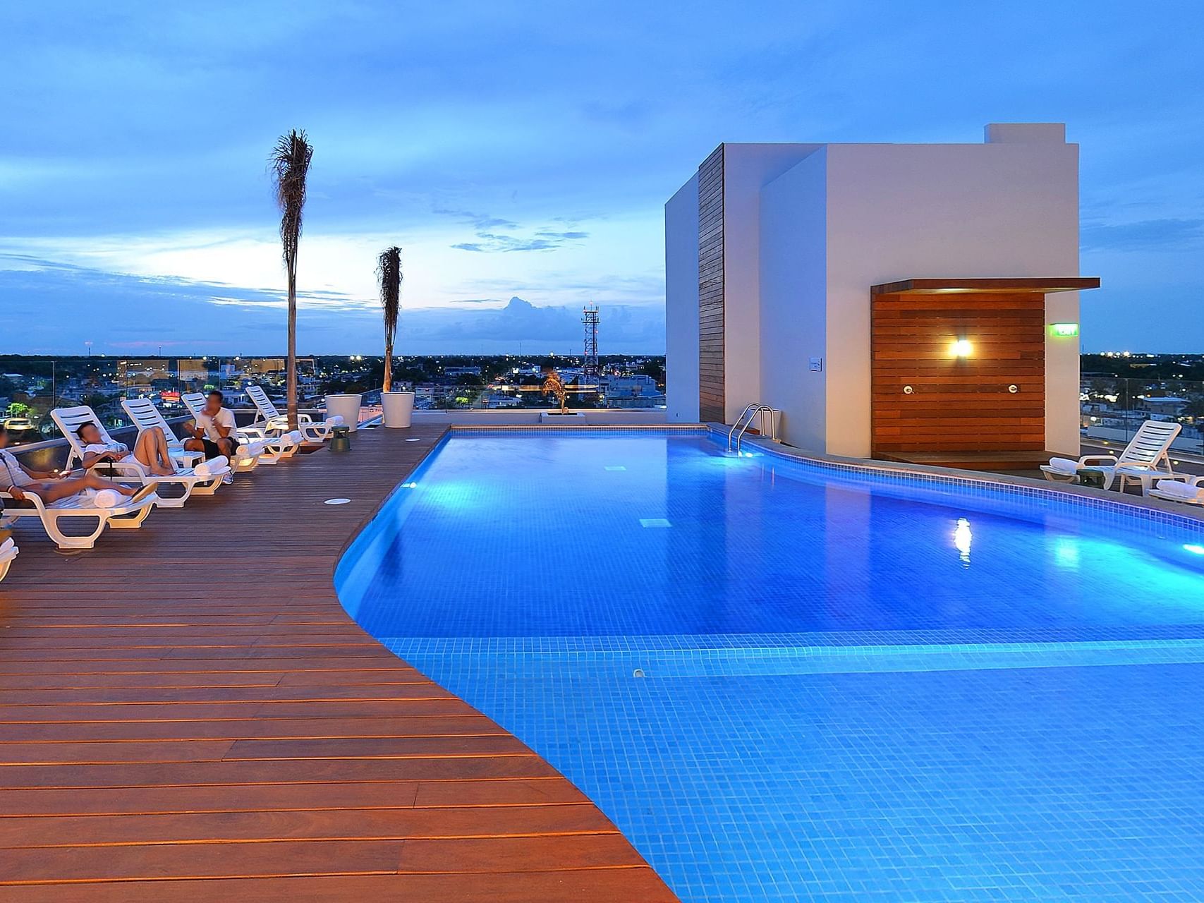 Outdoor swimming pool area with sunbeds at Fiesta Inn Hotels