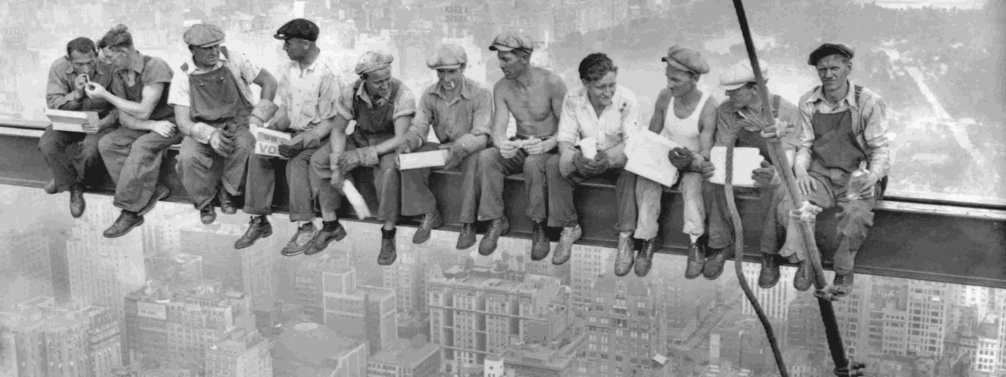 Group of workers sitting on a crane overlooking New York near Warwick New York