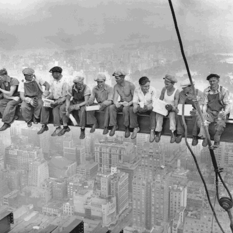 Group of workers sitting on a crane overlooking New York near Warwick New York