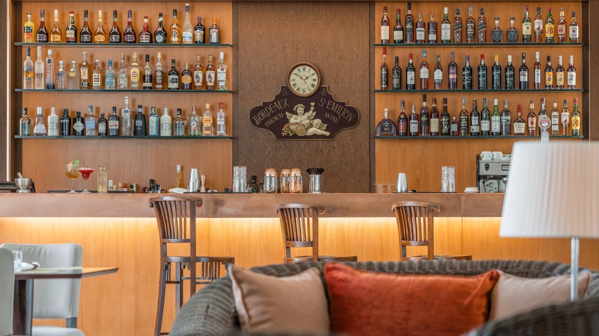 Collection of liquor bottles by the bar counter in Atlântida Restaurant at São Miguel Park Hotel