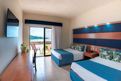 Double beds in room with sea view at Villas Sol Beach Resort