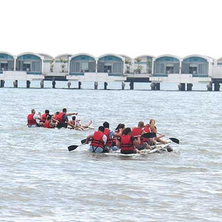 a group of people enjoying beach sport near Lexis Resort