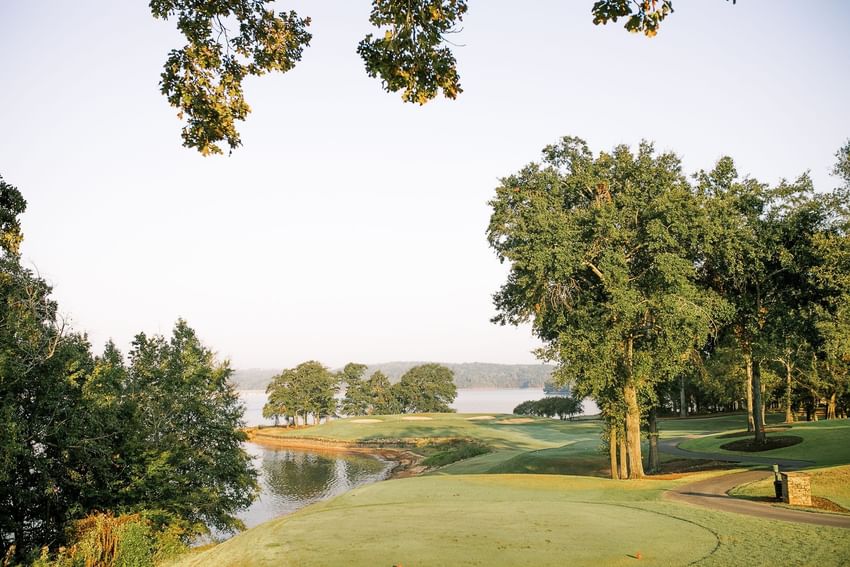 Scenic golf course landscape featuring lush green fairways and lake views at Clemson University Conference Center & Inn