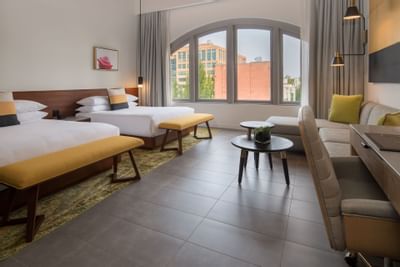 Hi-Lo hotel room with two beds, sofa and desk