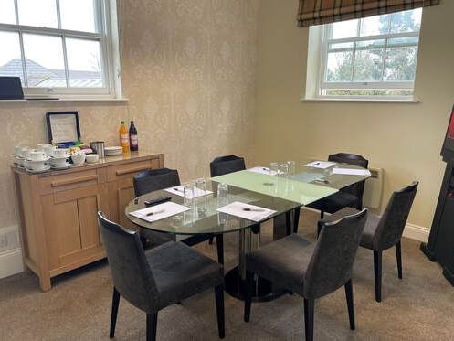 Glass table & Black chairs in Keane Room at Orsett Hall Hotel