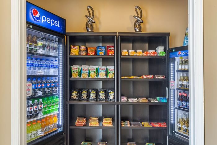 Fizzy drinks & snacks displayed on shelves at Ogunquit Collection