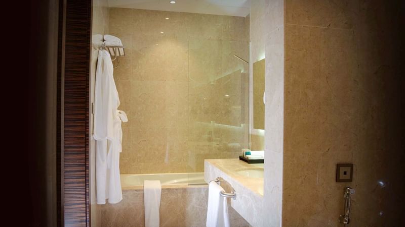 Bathtub & sink with vanity in Superior Twin Room at Warwick Al Khobar