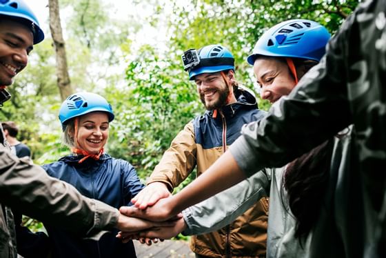 Trekkers putting their hands together at Honor's Haven Retreat