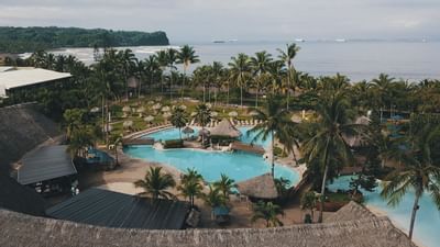 Aerial view of outdoor pool with palm tress at Fiesta Resort