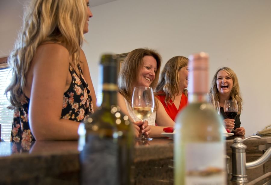 Group of ladies laughing while drinking wine at Lutsen Resort