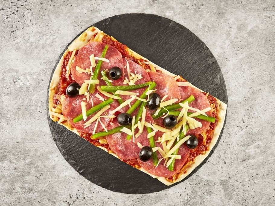 Close-up of a Pizza capriccioso served at One Hotels